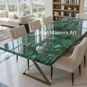 May include: A rectangular dining table with a glossy, green malachite top. The table has a gold-coloured metal base and is surrounded by cream-coloured chairs. The text "Asian Mason's Art" is visible on the table's surface.