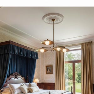 May include: A bedroom featuring a brass chandelier with four lights, each with a round, white bulb. The room has a dark blue canopy bed, beige curtains, and a decorative ceiling medallion.