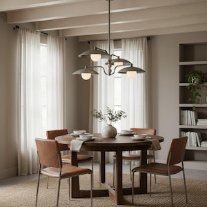 May include: A dining room set with a round wooden table, four brown leather chairs, and a metal chandelier with five lights. The room has sheer white curtains and a neutral color scheme.