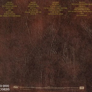 May include: A vintage album cover for "The Beatles: Love Songs" on Voo-Doo Records. The cover is a textured brown with song titles listed on the left and right sides. The album title and artist name are in gold.