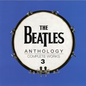 May include: The Beatles Anthology 3 CD album cover. The album cover features a drum with the band's name in bold black letters. The text "Anthology Complete Works 3" is also visible. The background is a solid blue.