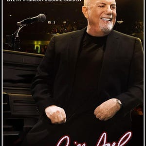May include: DVD cover for Billy Joel's "The 100th: Live at Madison Square Garden." The image features a smiling bald man in a black suit, with the artist's signature in red script. The DVD logo is in the bottom left corner.