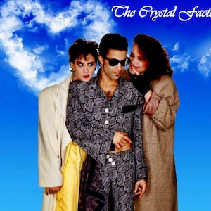 May include: Album cover for "Prince and the Revolution" featuring three people against a blue sky backdrop. The central figure wears a paisley print outfit and sunglasses. The text "The Crystal Factory" and "Prince and the Revolution" are visible.