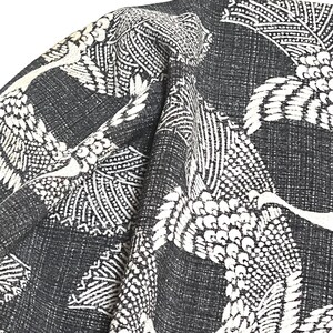 May include: Black fabric with a white crane pattern. The fabric has a textured woven look.