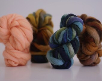 May include: Four skeins of yarn in different colors: peach, brown and green, blue and green. The yarn is soft and fluffy, perfect for knitting or crocheting.
