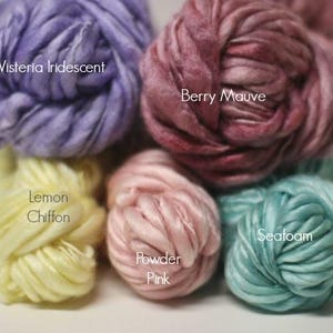 May include: Five skeins of yarn in different colors: Wisteria Iridescent, Berry Mauve, Lemon Chiffon, Powder Pink, and Seafoam.