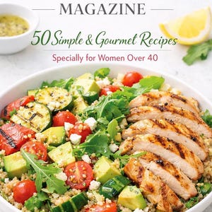 May include: A white bowl filled with a colorful salad featuring grilled chicken, tomatoes, avocado, and greens. The image also includes a small bowl of dressing, a lemon wedge, and the text "SLIMMING MAGAZINE".