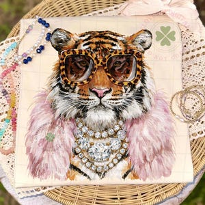 May include: A whimsical illustration of a tiger wearing leopard print sunglasses, a pink feather boa, and a diamond necklace. The tiger's fur is orange and black. The background is a cream color.