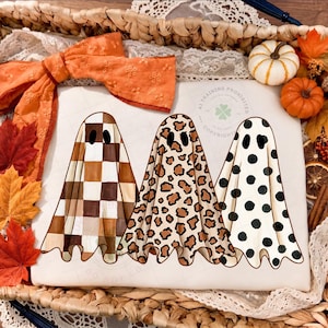 Preppy Ghosts Trio PNG — three hand-drawn ghosts in checkered, leopard print and polka dot patterns, cozy boho fall Halloween sublimation design.