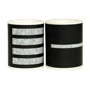 May include: Two black and white striped ceramic mugs. The mug on the left has four white stripes, and the mug on the right has one white stripe.