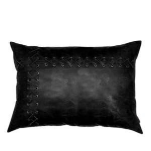 May include: A rectangular black pillow with a stitched design. The pillow features a leather-like texture and decorative stitching along the edges and across the center, creating a unique, handcrafted appearance. The pillow is designed for decorative use.