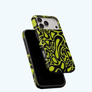 K&ouml;nnte beinhalten: Zwei schwarze Smartphones mit H&uuml;llen. Die H&uuml;llen haben ein abstraktes Muster in Neongr&uuml;n und Schwarz. Die Telefone sind abgewinkelt, eines &uuml;ber dem anderen, um das Design auf der R&uuml;ckseite der H&uuml;llen hervorzuheben.