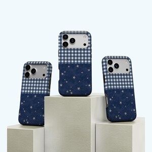 May include: Three phone cases with a navy blue and white gingham pattern at the top and a navy blue starry night design on the bottom. The cases are displayed on a white background.