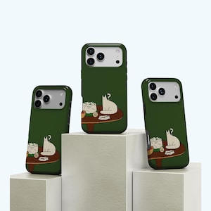 May include: Three green phone cases with a cat and table design. The cases feature a white cat with a question mark above its head, sitting at a brown table with food. The table is set with a bowl and a stack of food. The cases are displayed on white blocks.