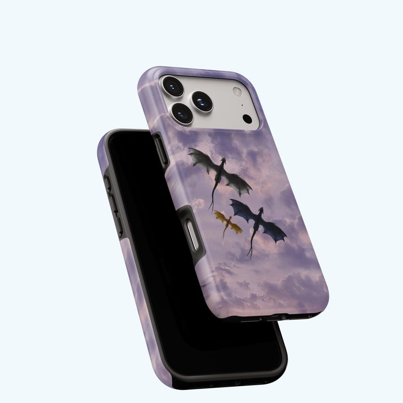 May include: A phone case featuring a fantasy scene with three dragons soaring through a cloudy, purple sky. The case is a light purple color with a black border and a glossy finish. The design is a digital illustration.