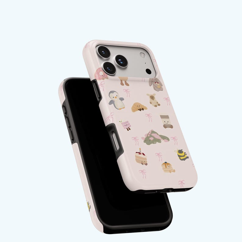 May include: A light pink phone case featuring a pattern of cartoon animals and small pink bows. The case is designed to protect the phone and has a black interior. The case is shown slightly open, revealing the phone's screen.