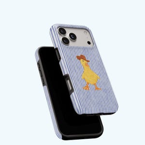 May include: A phone case with a blue and white striped pattern featuring a yellow duck wearing a brown cowboy hat. The phone case is shown in two parts, with the phone inside the case.