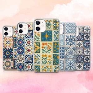 May include: A collection of five phone cases with colorful, patterned designs. Each case features a different tile-like pattern in shades of blue, yellow, and red, with floral and geometric motifs. The cases are made of clear plastic.