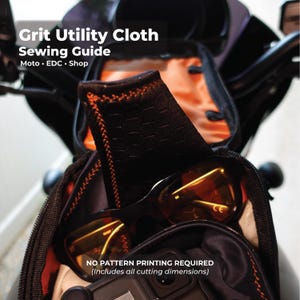 May include: Black bag with orange stitching, containing sunglasses and other items. The text "Grit Utility Cloth Sewing Guide" is at the top. Below the text is "Moto • EDC • Shop". The text "NO PATTERN PRINTING REQUIRED (Includes all cutting dimensions)" is at the bottom.