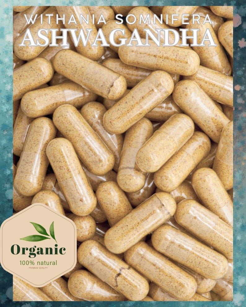 May include: Close-up of Ashwagandha capsules, a natural supplement. The capsules are light brown and filled with a powder. The image includes the text "Withania Somnifera Ashwagandha" and an "Organic" label, indicating a focus on natural health products.