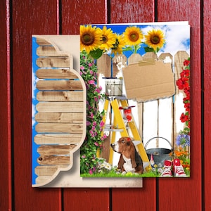 May include: A whimsical greeting card featuring a garden scene with sunflowers, a white picket fence, and a Basset Hound. A yellow ladder, paint can, and red trainers add to the playful design. The card is set against a red wooden background.