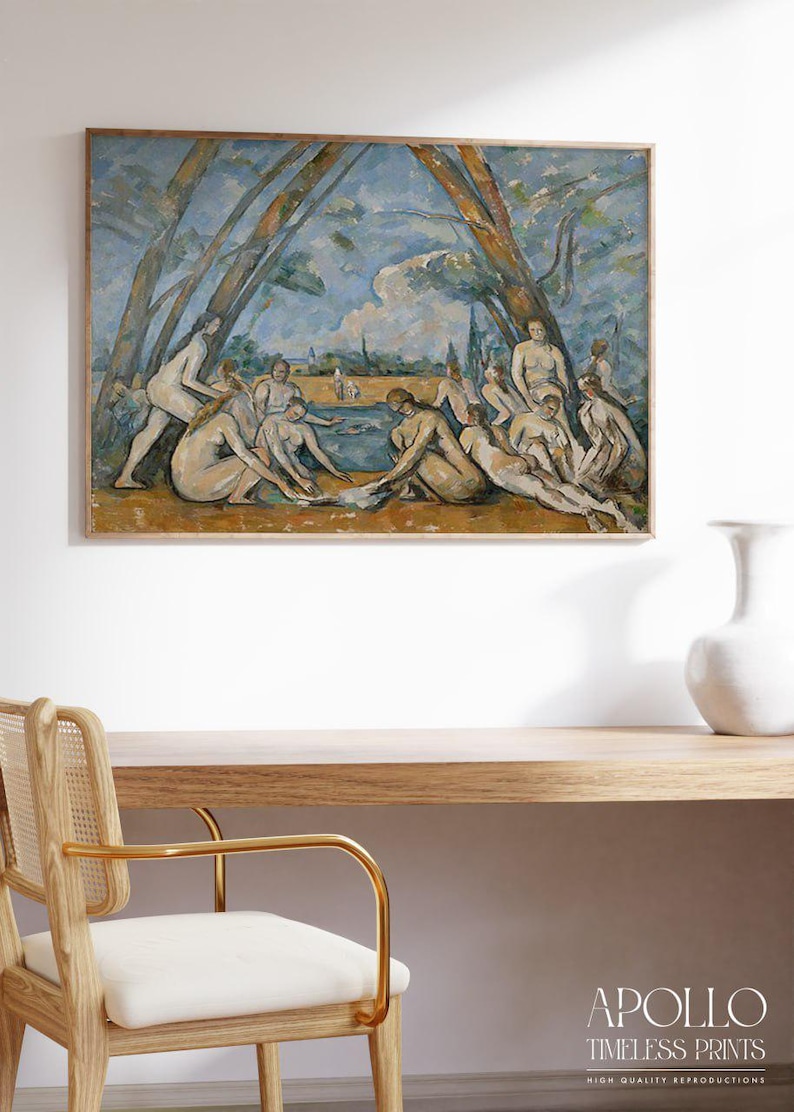 A high-quality reproduction of Paul Cézanne’s painting “The Large Bathers,” showing a group of nude figures gathered beside a river in a natural outdoor setting. Tall trees frame the scene and the sky is painted in cool blues and soft tones, with expressive brushstrokes creating a classical museum-style atmosphere.