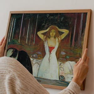 May include: A framed print of a painting featuring a woman in a white dress with red accents, set against a dark forest backdrop. The artwork has a vintage aesthetic, with the text "APOLLO TIMELESS PRINTS" at the bottom.