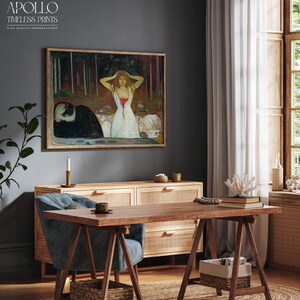 May include: A framed print of a painting hangs above a wooden cabinet. The artwork depicts a woman in a white dress with red accents, set against a forest backdrop. The text "APOLLO TIMELESS PRINTS" is in the upper left corner.