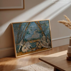 May include: A framed print of a classical painting featuring nude figures near a body of water, with trees and a blue sky in the background. The frame is light brown. The text "APOLLO TIMELESS PRINTS HIGH QUALITY REPRODUCTIONS" is visible.