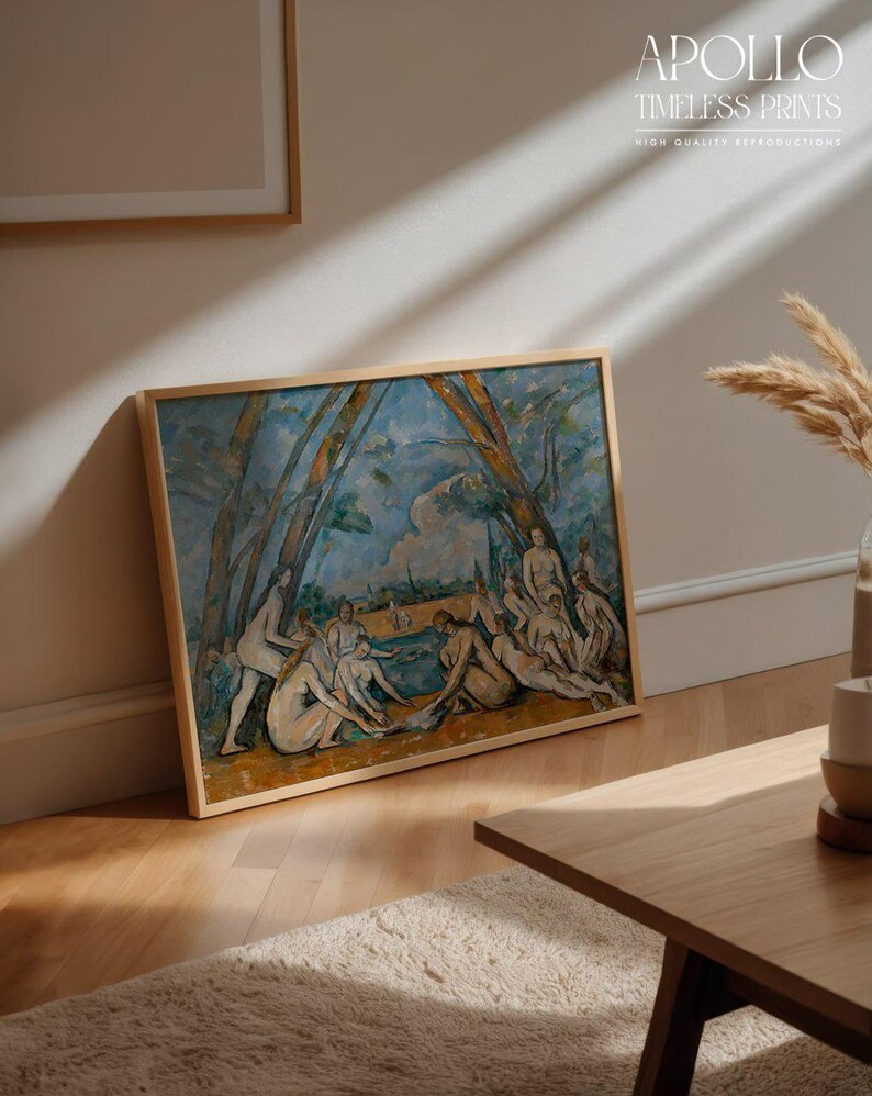 May include: A framed print of a classical painting featuring nude figures near a body of water, with trees and a blue sky in the background. The frame is light brown. The text "APOLLO TIMELESS PRINTS HIGH QUALITY REPRODUCTIONS" is visible.