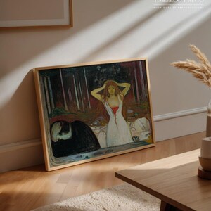 May include: A framed print of a painting featuring a woman in a white dress with red accents, and a dark figure. The artwork is in a wooden frame and leans against a wall. The text "APOLLO TIMELESS PRINTS" is visible.