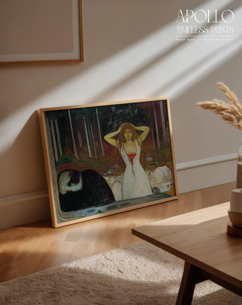 May include: A framed print of a painting featuring a woman in a white dress with red accents, and a dark figure. The artwork is in a wooden frame and leans against a wall. The text "APOLLO TIMELESS PRINTS" is visible.