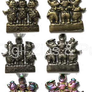 May include: Four different versions of a three little pigs keychain charm. The charms are made of metal and feature the three pigs standing on a brick wall. The pigs are wearing hats and have different colored finishes, including gold, silver, and rainbow.