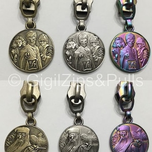 May include: Six zipper pulls with different colored metal finishes. Each pull features a round charm with a Harry Potter themed design. The charms feature characters from the Harry Potter series, including Harry Potter, Ron Weasley, Hermione Granger, and Albus Dumbledore.