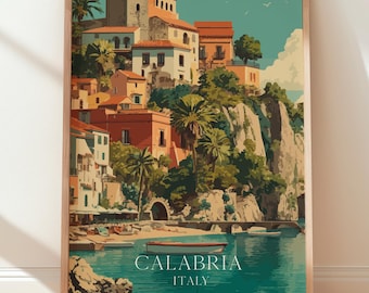 May include: A framed art print depicting a coastal Italian town. The artwork features buildings with red tile roofs, palm trees, and a turquoise sea. The text "CALABRIA ITALY" is printed at the bottom of the image.