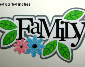 May include: A white paper cutout of the word "Family" in black with green leaves and pink and blue flowers. The cutout measures 5 3/4 x 3 1/4 inches.