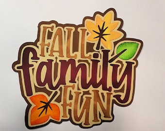 May include: Fall Family Fun, a decorative paper craft with the words "Fall Family Fun" in brown and burgundy lettering with fall leaves in orange, yellow, and green. The craft measures 4 1/2 by 5 inches.