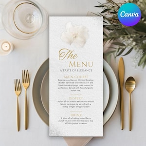 May include: A wedding menu card with gold text and a floral design. The menu lists a main course of chicken and a dessert of lemon meringue pie. Gold forks, a knife, and a spoon are on the table.