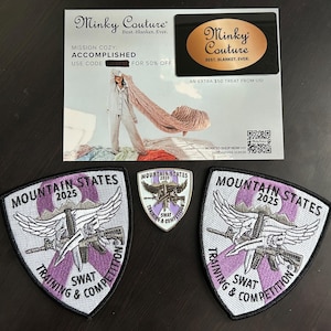 May include: An assortment of items including two embroidered patches with the text "MOUNTAIN STATES 2025 SWAT TRAINING & COMPETITION", a smaller patch, and a promotional card from Minky Couture.