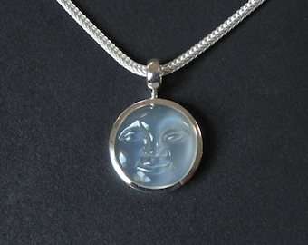 silver necklace with carved moon face pendant
