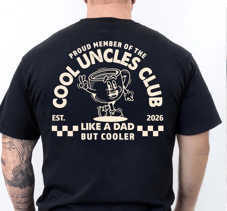 May include: Black t-shirt with a white graphic of a cartoon coffee cup giving a peace sign. The text reads "COOL UNCLES CLUB" and "LIKE A DAD BUT COOLER". The shirt also has the text "EST. 2026".