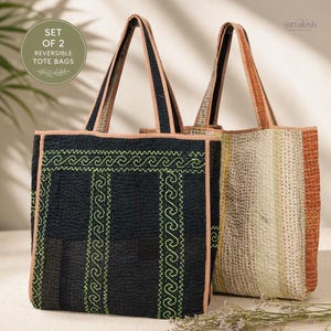 May include: A set of two reversible tote bags featuring quilted fabric with visible running stitches. One bag is black with lime green geometric wave patterns, while the other features vertical stripes in cream, tan, and orange. Text reads SET OF 2.