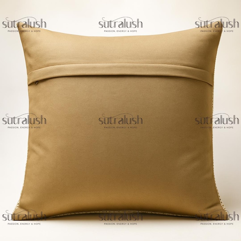 May include: A square, tan-colored pillow with a textured surface. The pillow has a zipper closure on the back and a decorative trim along the edges. The brand name "sutralush" is printed on the pillow.