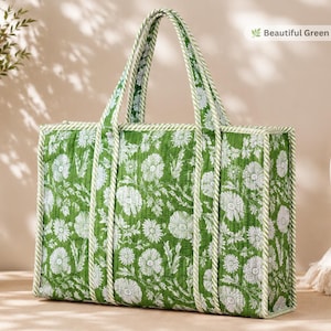 May include: A rectangular quilted tote bag featuring a green and white floral print. The bag has two top handles and is trimmed with a green and white striped fabric piping. The text "Beautiful Green Floral Print" is visible in the corner.