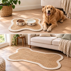 May include: A bone-shaped pet mat featuring a natural tan woven center with a thick, cream-colored braided border. The mat is designed to hold two round ceramic bowls, each decorated with small black paw print patterns around the exterior rim.