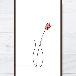 May include: A framed minimalist art print featuring a single-line drawing of a flower in a vase. The flower has a pink bud, and the vase is black. The artwork is set against a white background.
