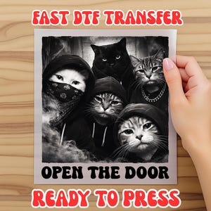 May include: Black and white image of five cats wearing hoodies and bandanas. The text "FAST DTF TRANSFER", "OPEN THE DOOR", and "READY TO PRESS" are displayed in red and black. The image is held by a person.