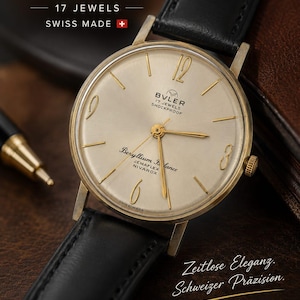 May include: A Buler wristwatch with a gold-tone round case, a champagne-colored dial, and a black leather strap. The dial features gold-tone hour markers, the text Buler 17 Jewels Shockproof, Beryllium Balance, Jemaflex, Nivarox, and Swiss Made.