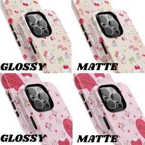 May include: Four phone cases with Hello Kitty designs. Two cases have a glossy finish, and two have a matte finish. The cases feature a repeating pattern of Hello Kitty, bows, strawberries, and other decorative elements. The text "GLOSSY" and "MATTE" are printed on the cases.