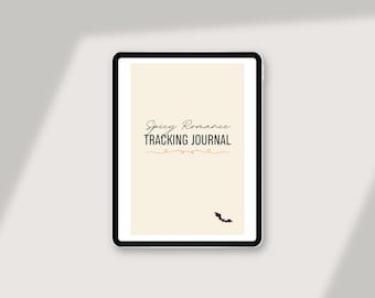 May include: A digital tablet displays a cream-colored page with the text "Spicy Romance Tracking Journal" in black script. A small bat illustration is at the bottom. The tablet has a black border and is set against a light background.